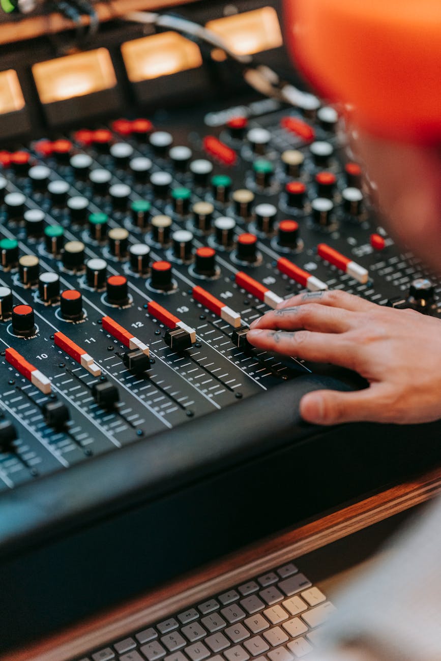close up of man mixing music on a console