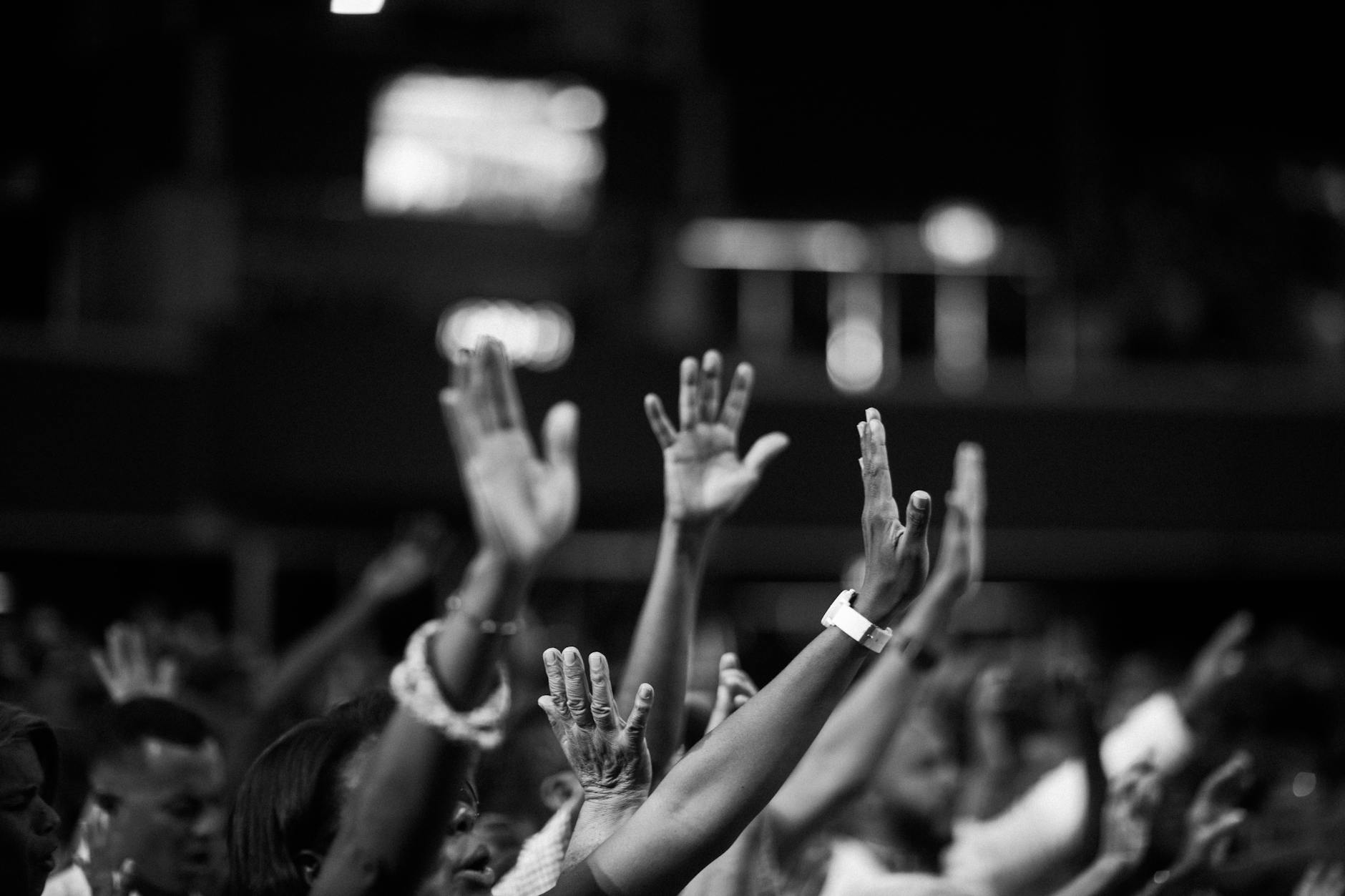 grayscale photography of people raising hands, Christian Social Issues