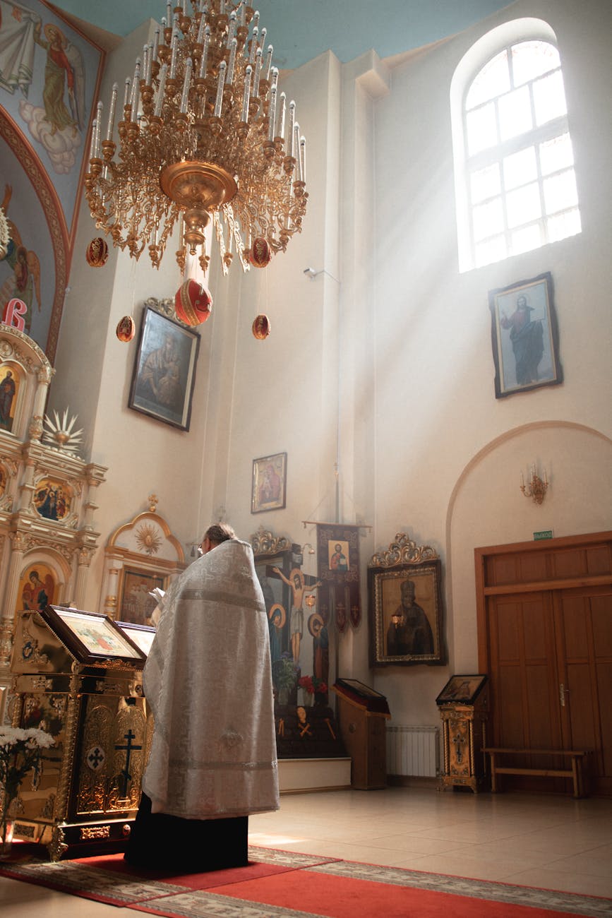 priest conducting ceremony in sunlit church interior