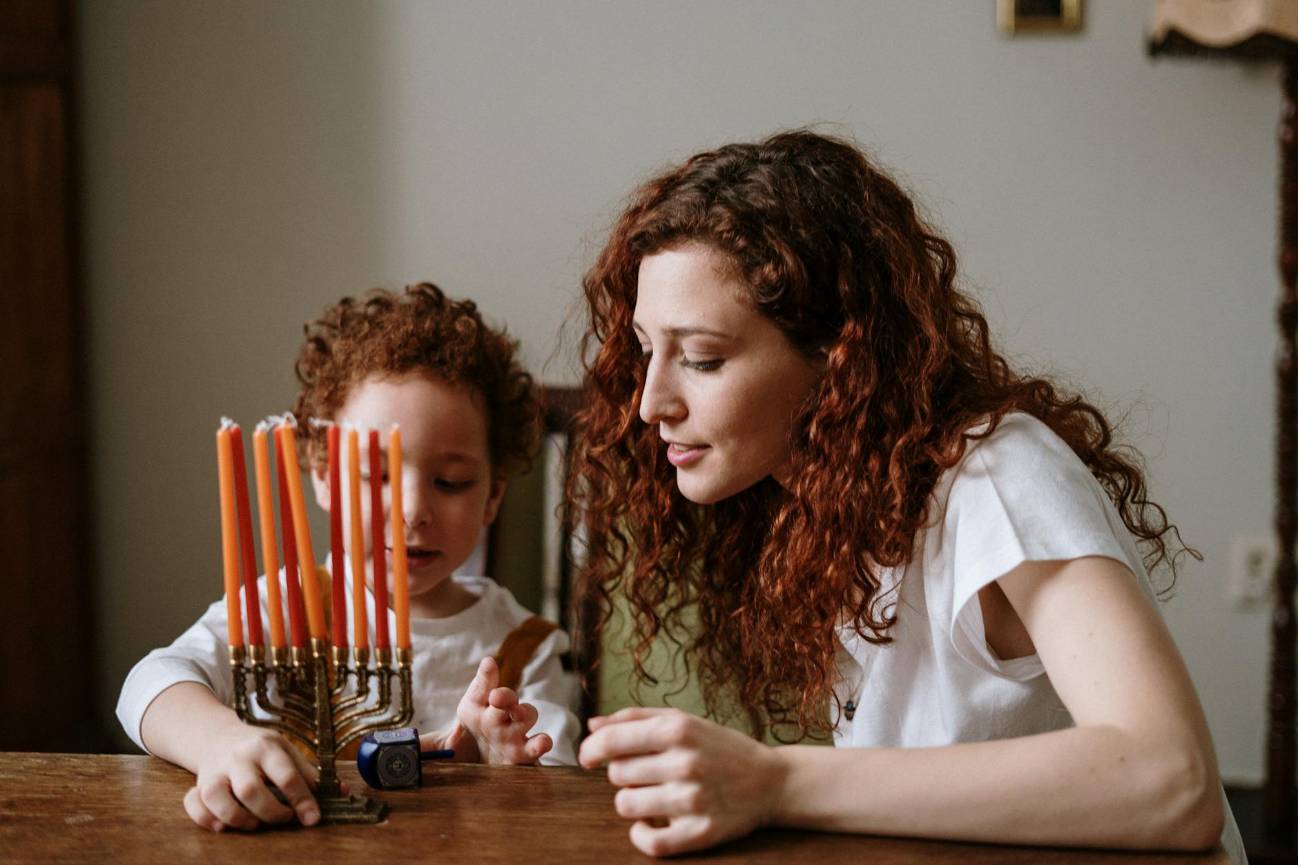 mother and son with a menorah
