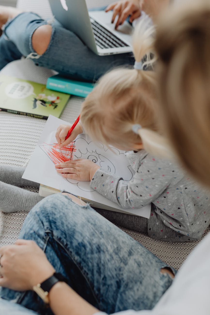 girl sitting on sofa and drawing, coloring books