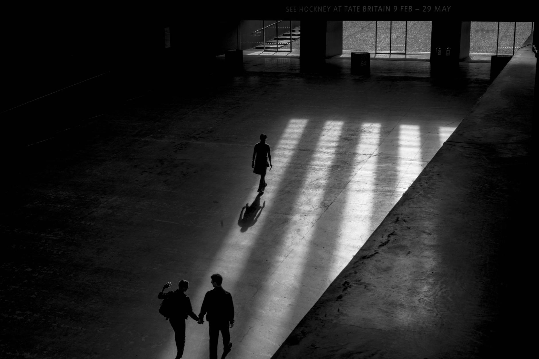 grayscale photo of three men walking inside building, Museum Industry