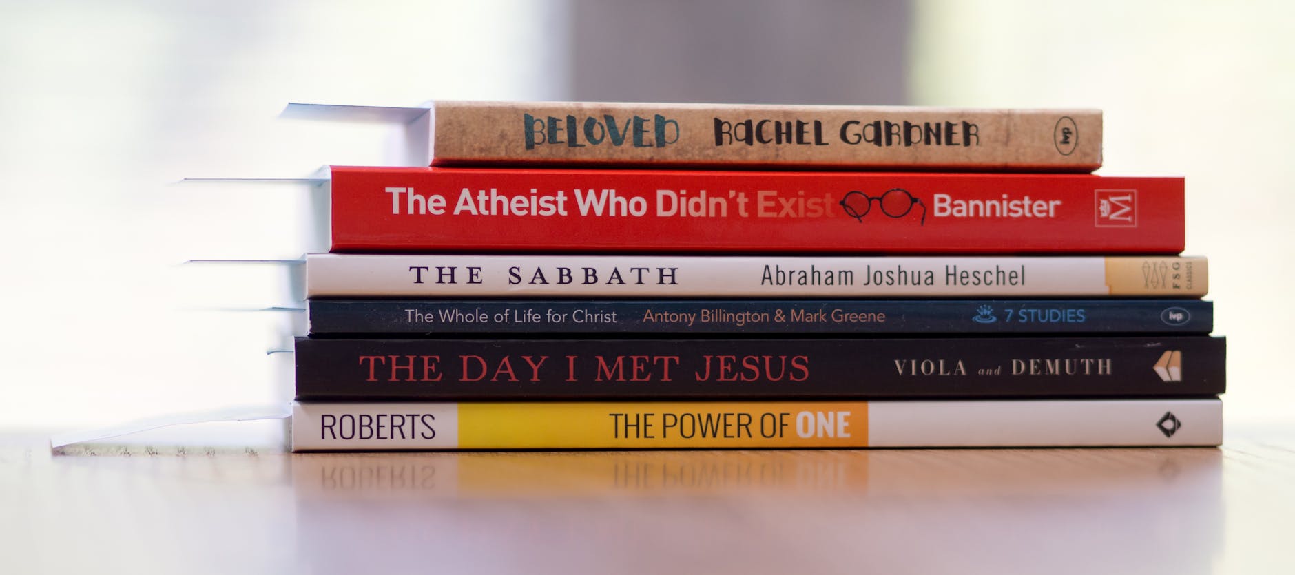 six assorted title books on white desk