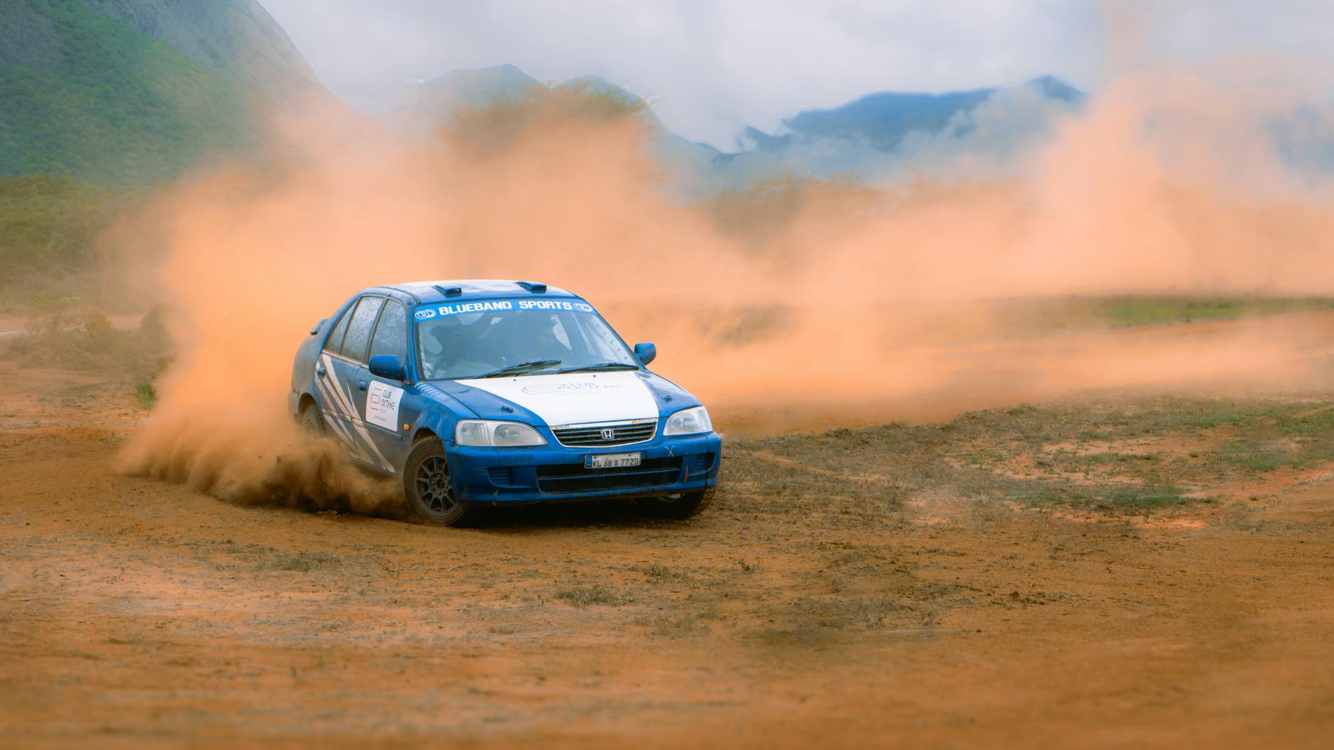rally car racing on dirt track in desert