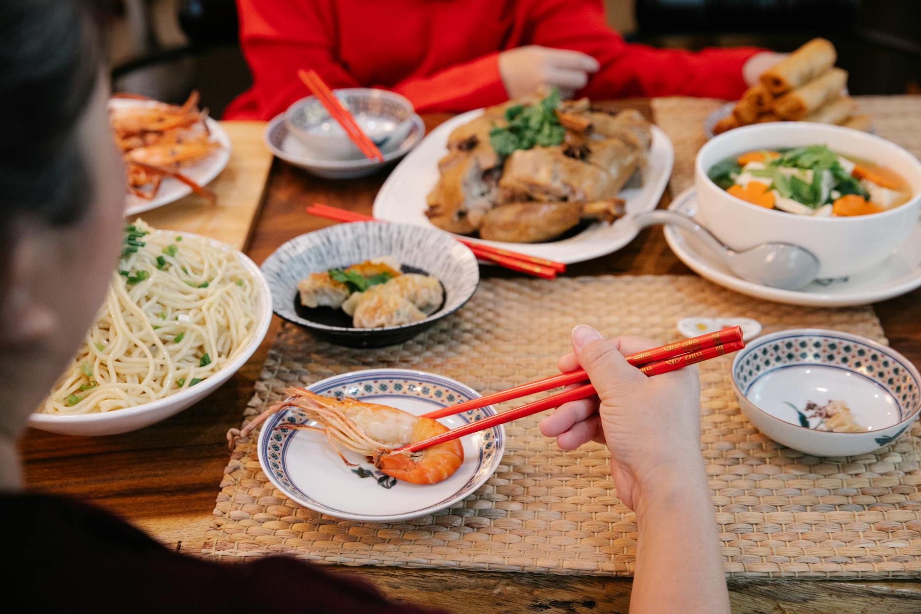 a woman using chopsticks to eat