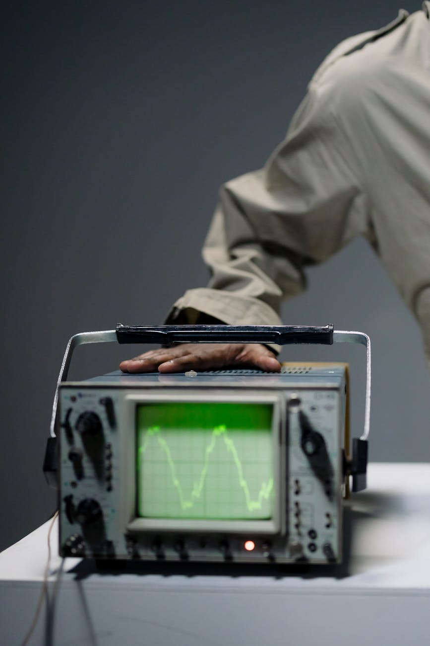 a man touching an electronic equipment with electronic signal