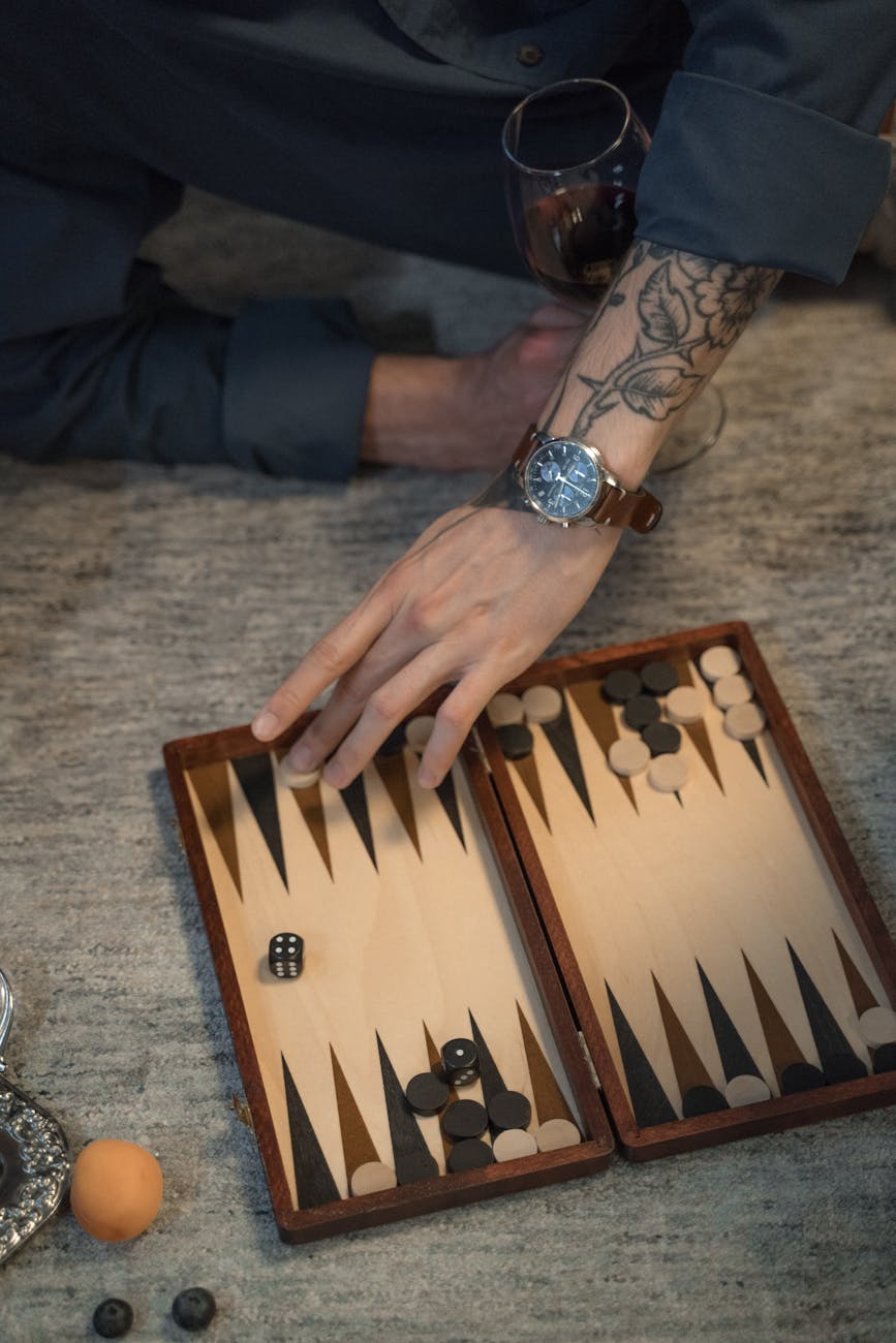 close up of man playing backgammon on floor