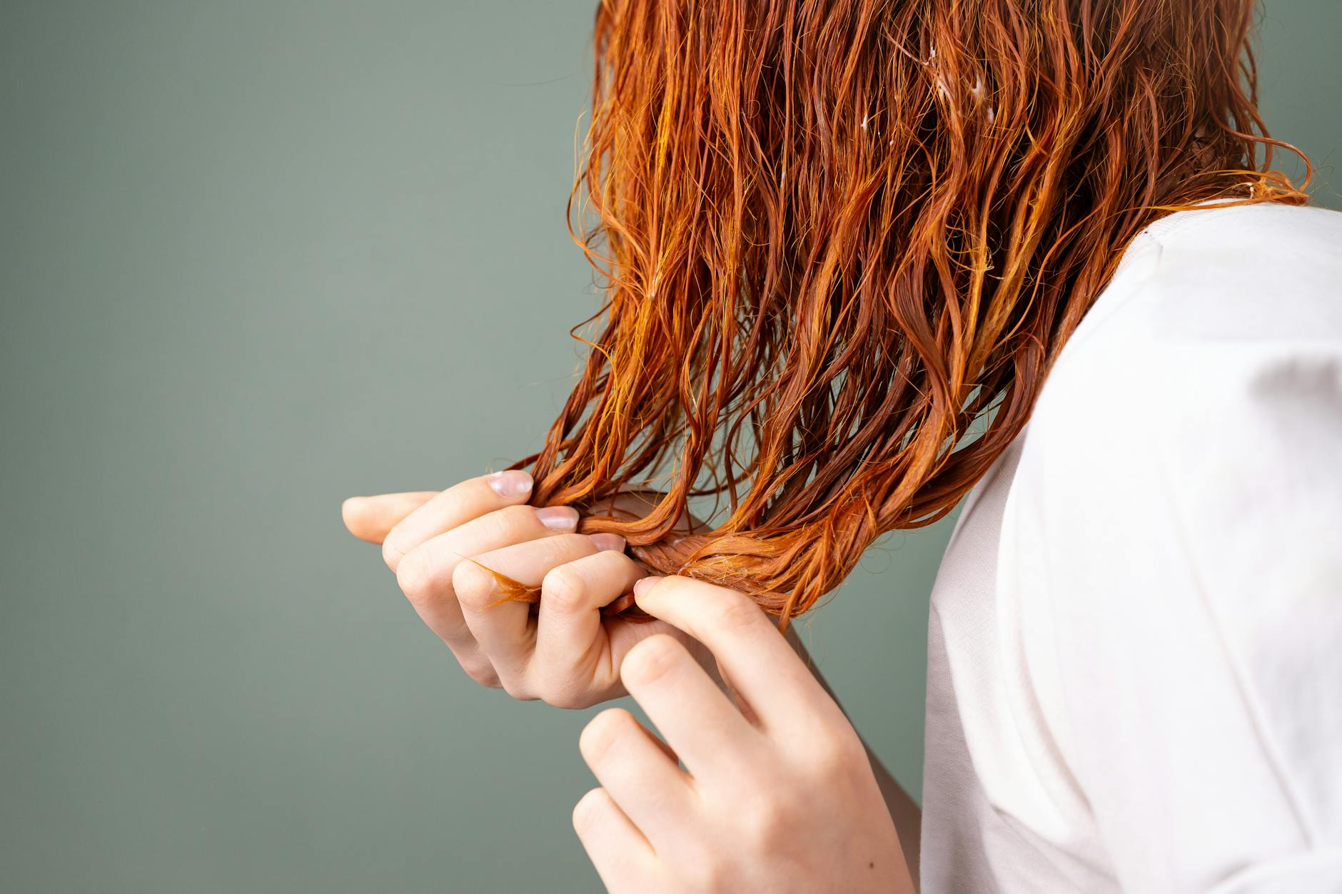 close up of red hair and hands in soft lighting, Hair Care and Styling