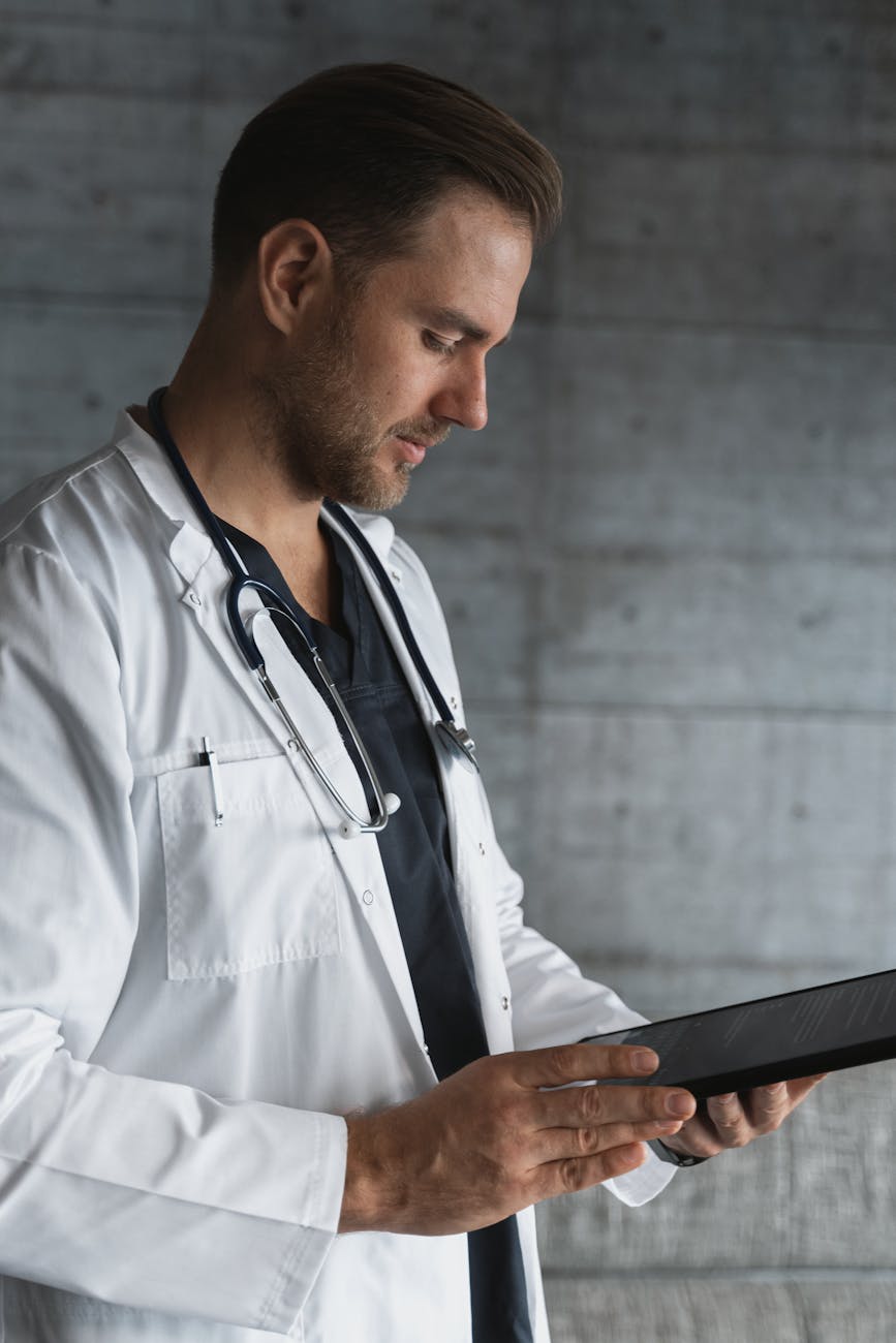 man in white button up shirt holding black tablet computer, Prostate Disease