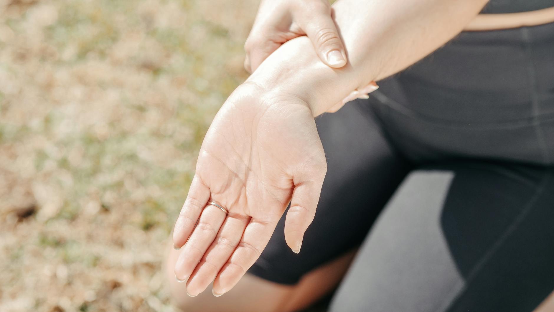 close up photo of a woman stretching her wrist