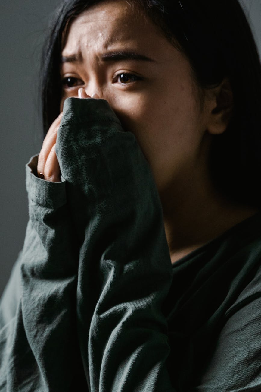 a fearful woman covering her mouth