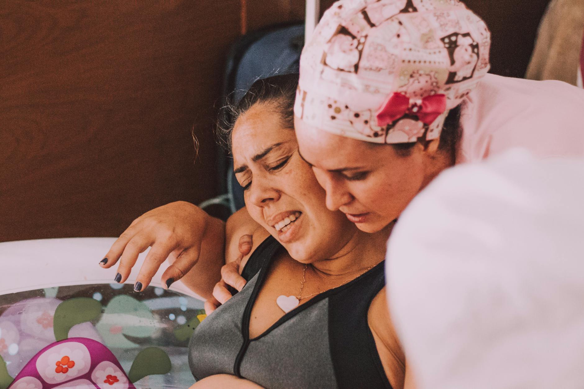 supportive midwife assisting in water birth