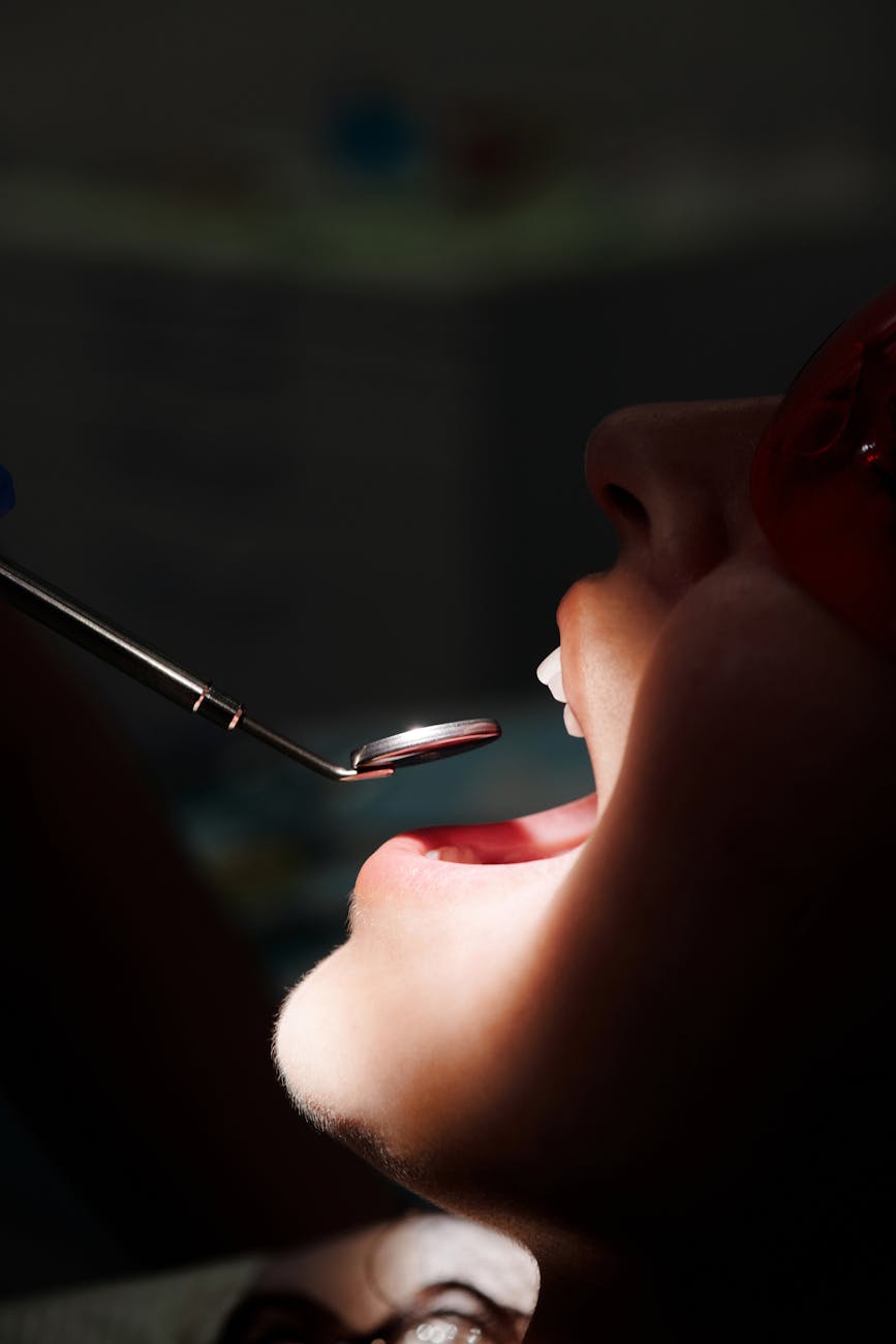 a dental tool in front of a mouth
