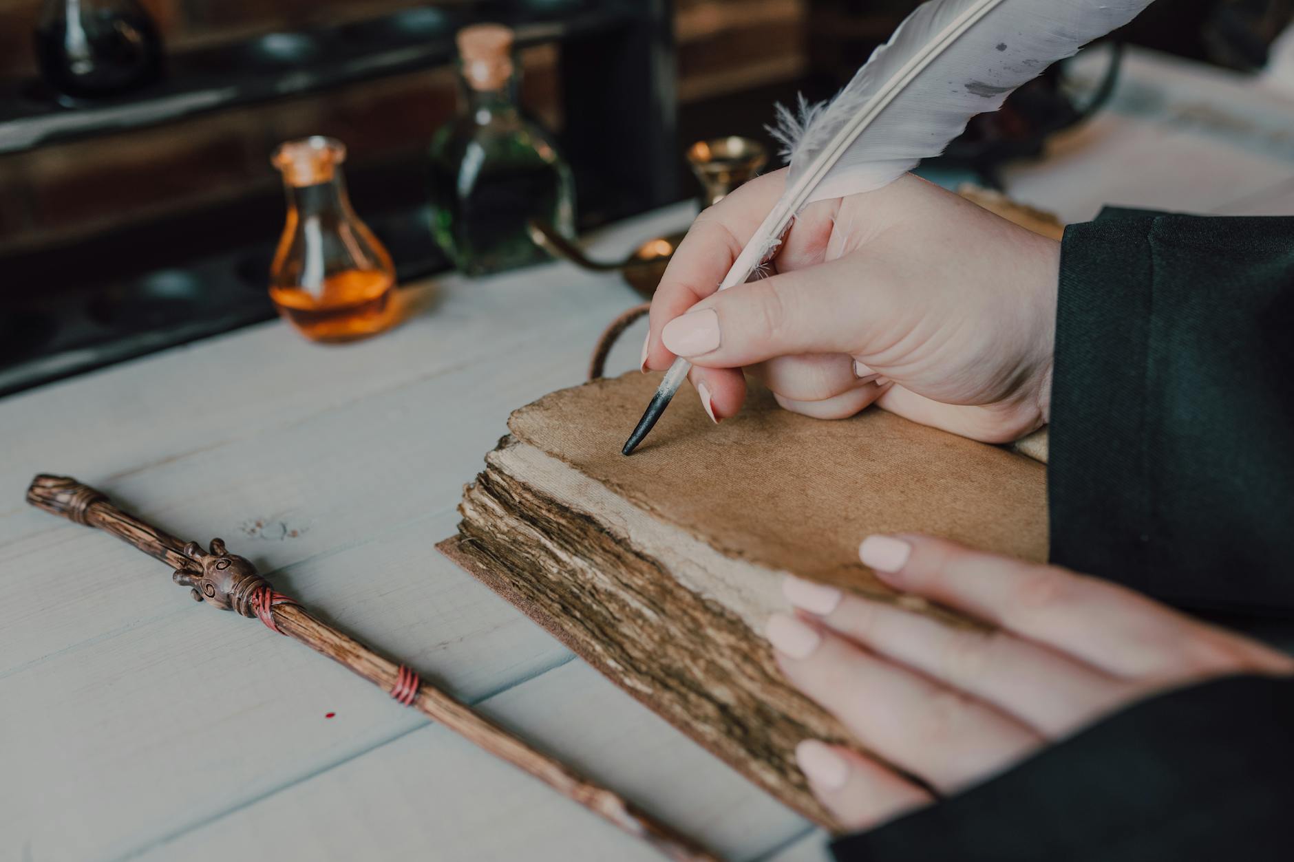 close up shot of a person writing on a spell book, Historical Fiction Anthologies 