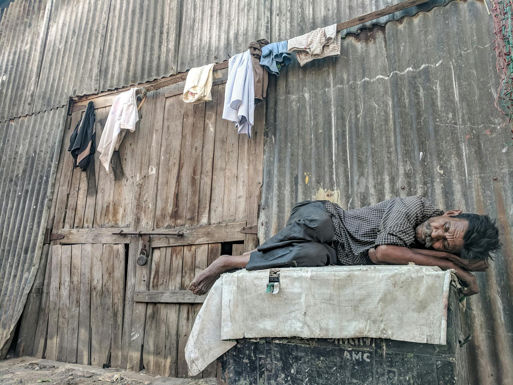 man sleeping in front of a building