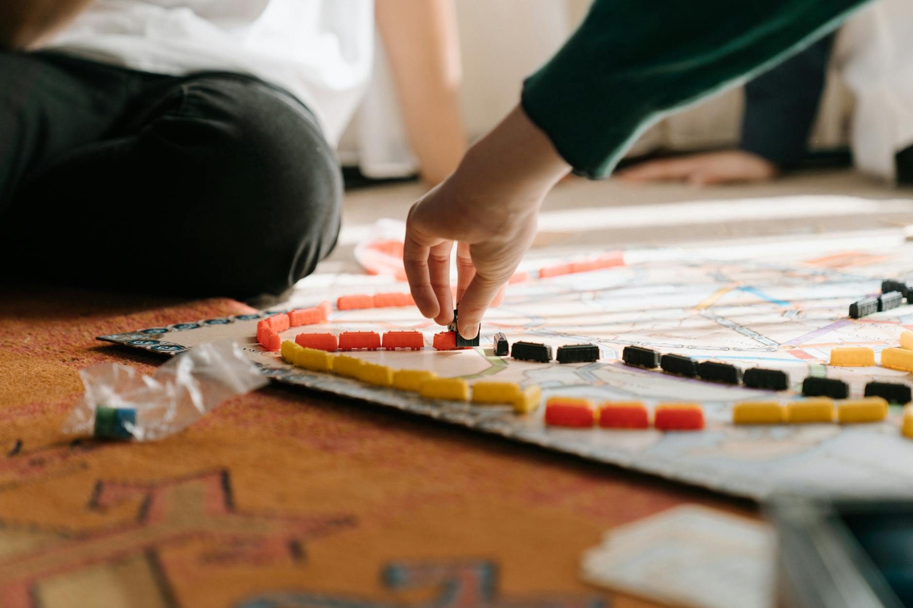 person holding yellow and red plastic toy, tabletop role-playing game system