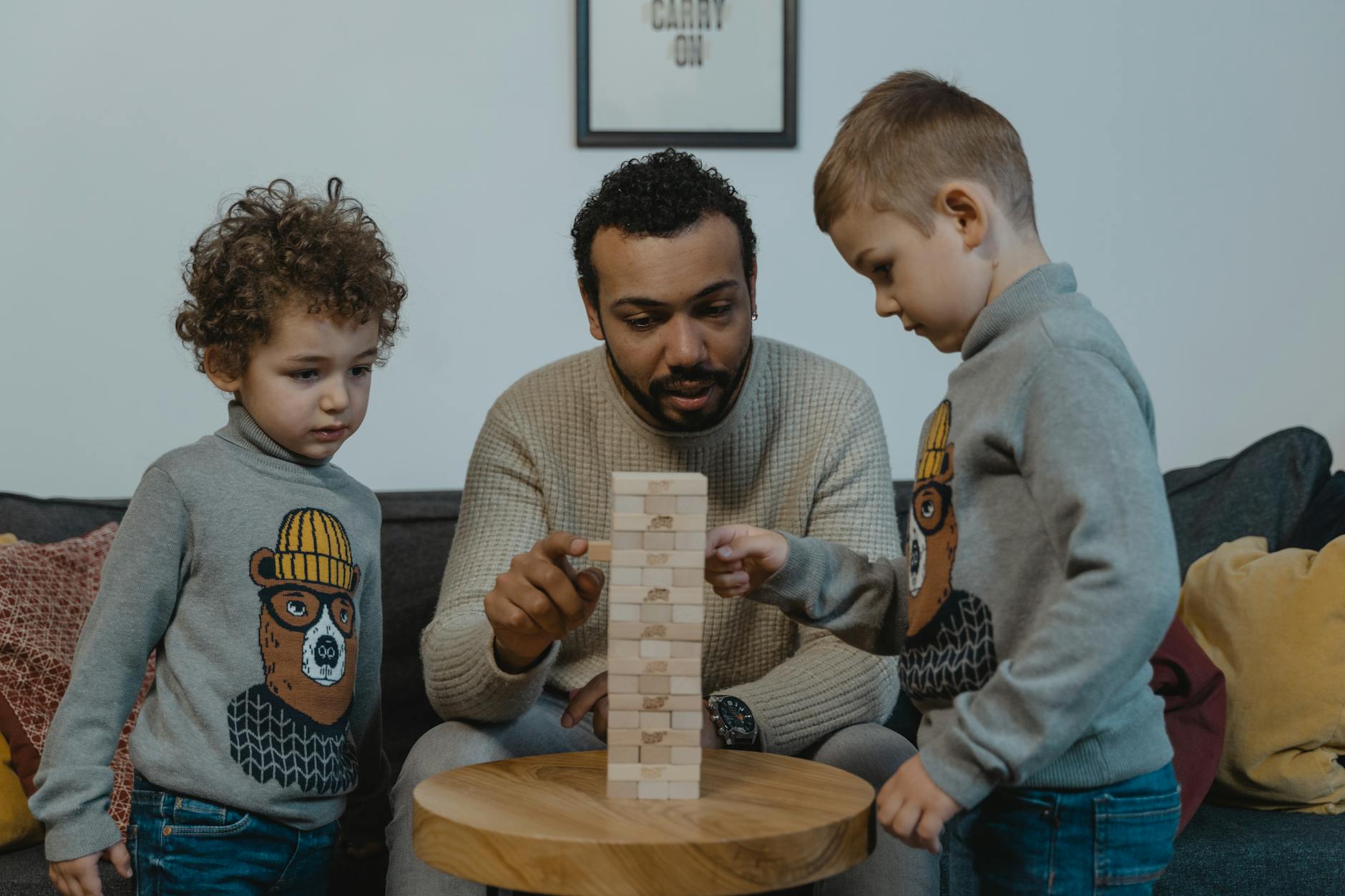 a man playing a wooden blocks with his kids