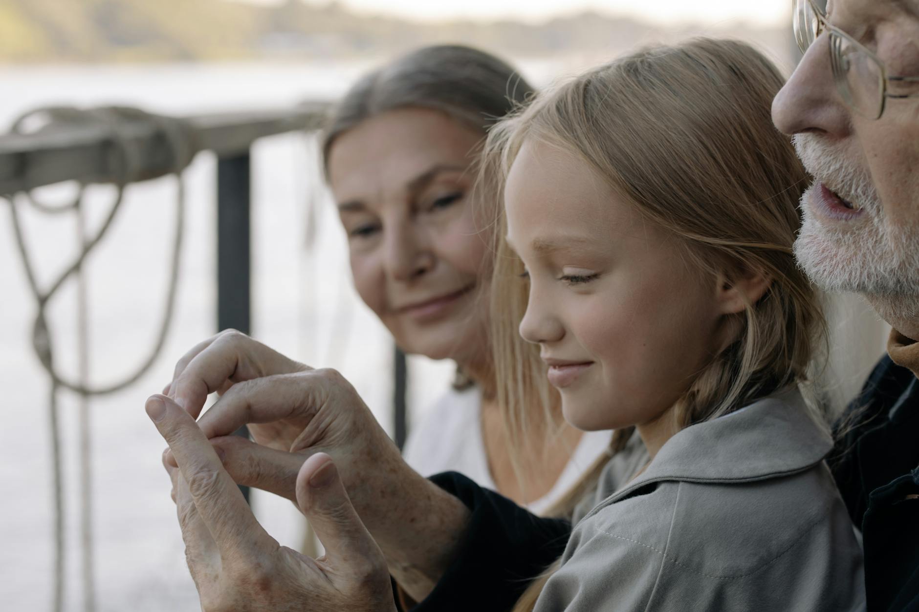 girl in gray long sleeve shirt smiling with her grandparents