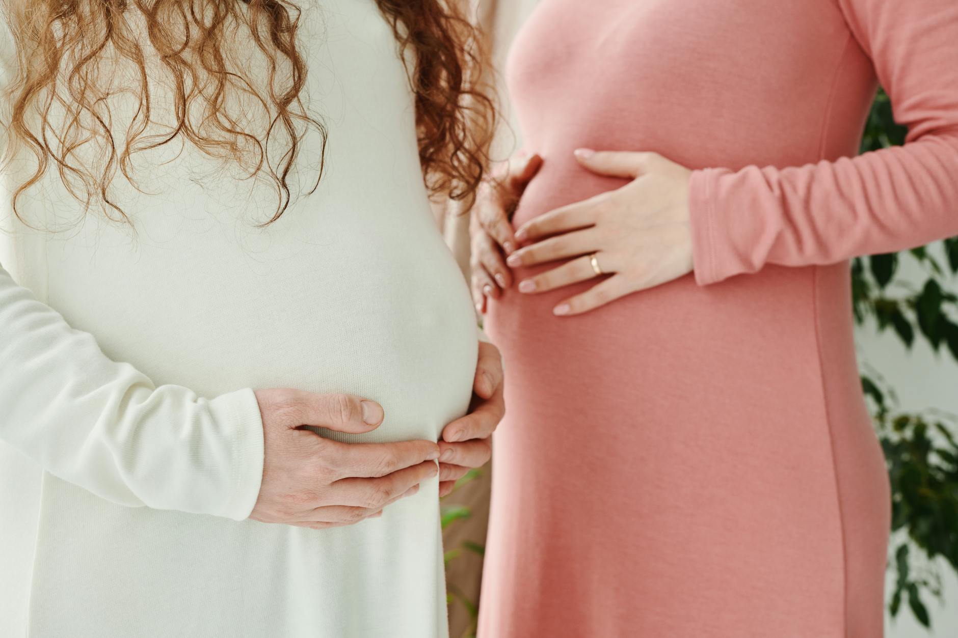 pregnant women with their hands on belly