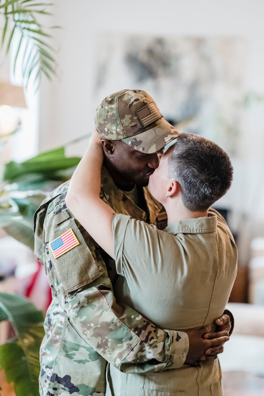 a soldier kissing his wife