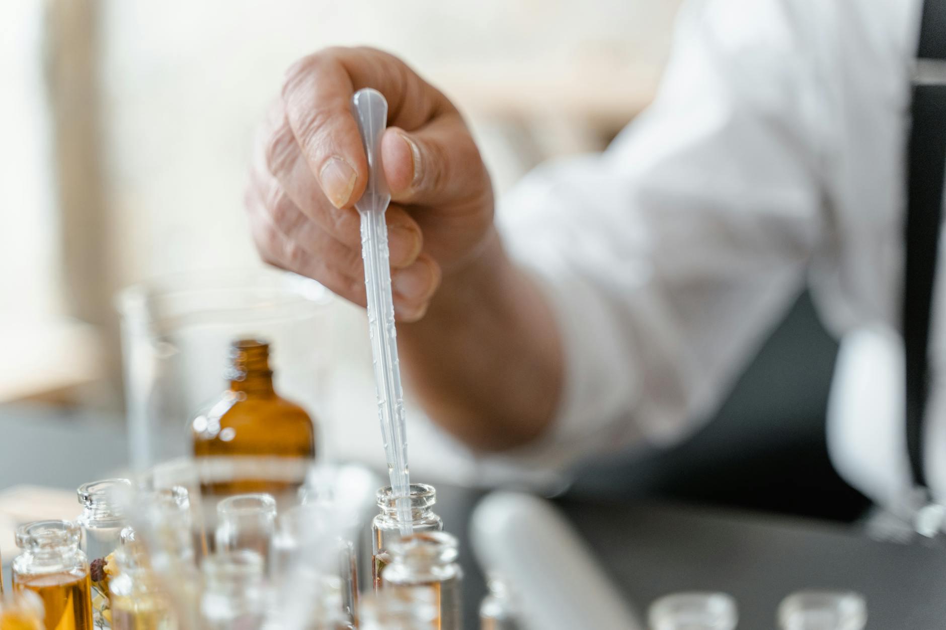 person holding clear glass tube, Heterocyclic Organic Chemistry
