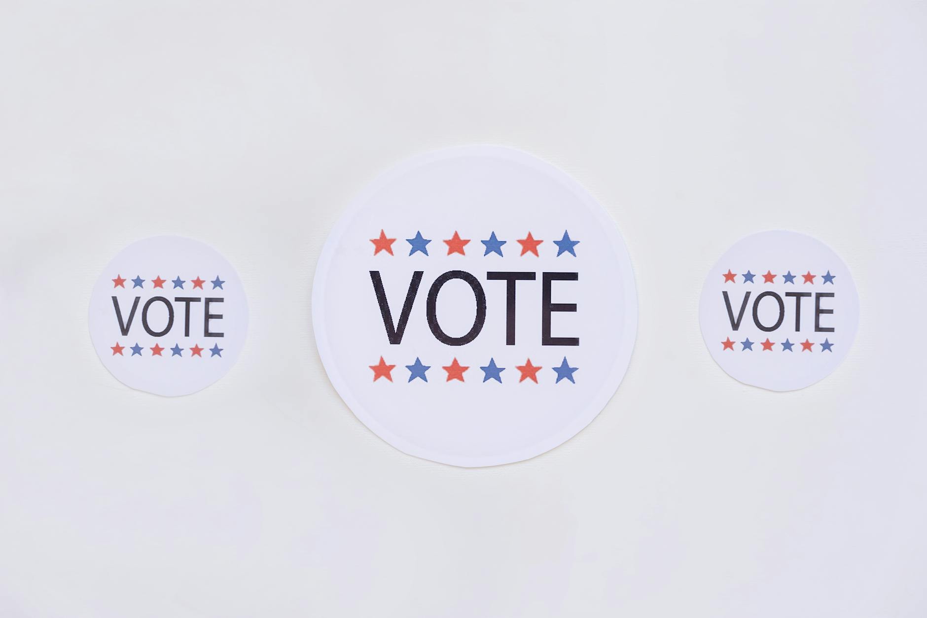 vote badges on white surface, Political Advocacy