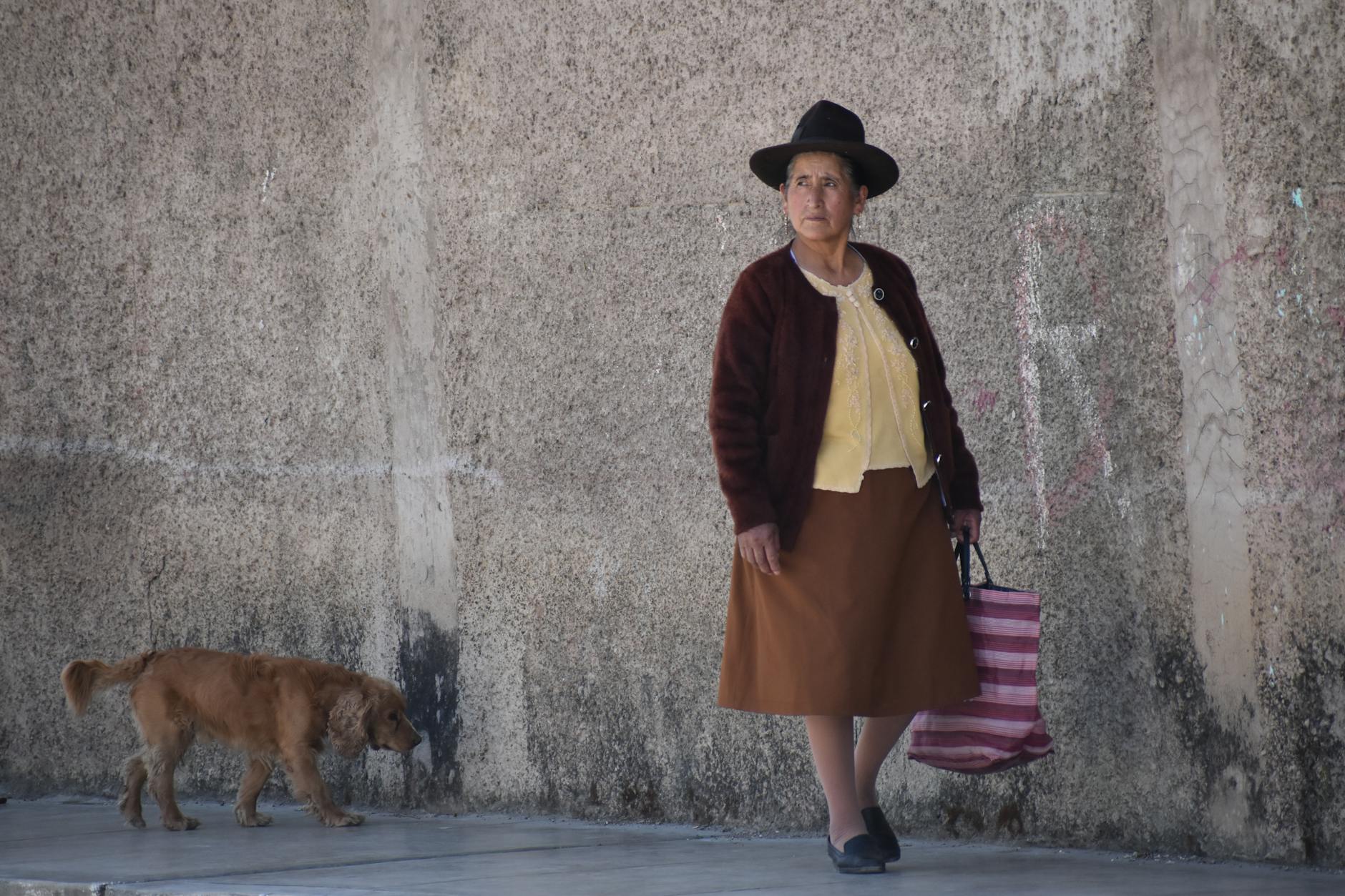 traditional peruvian woman with dog in huaraz