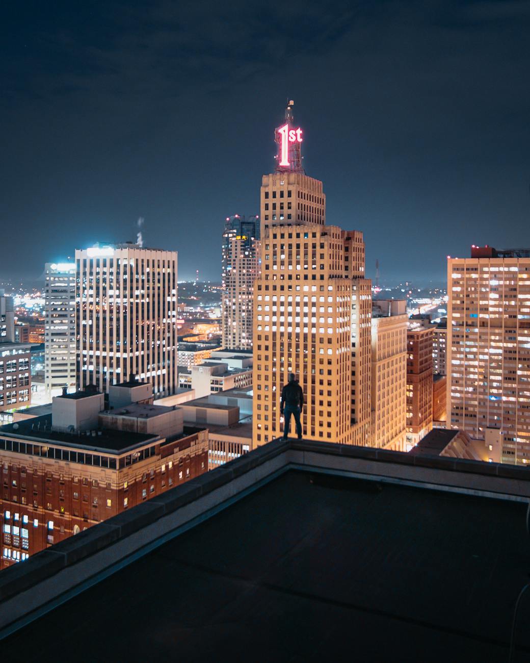person standing at the edge of building at night, Minnesota