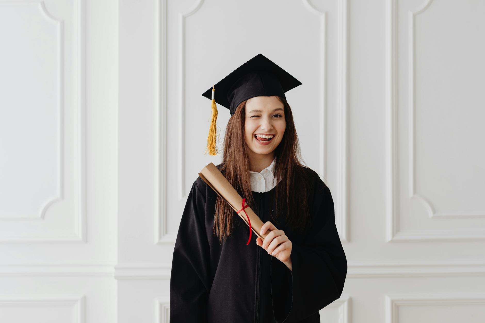 woman in academic dress smiling with her tongue out, Graduate School Preparation 